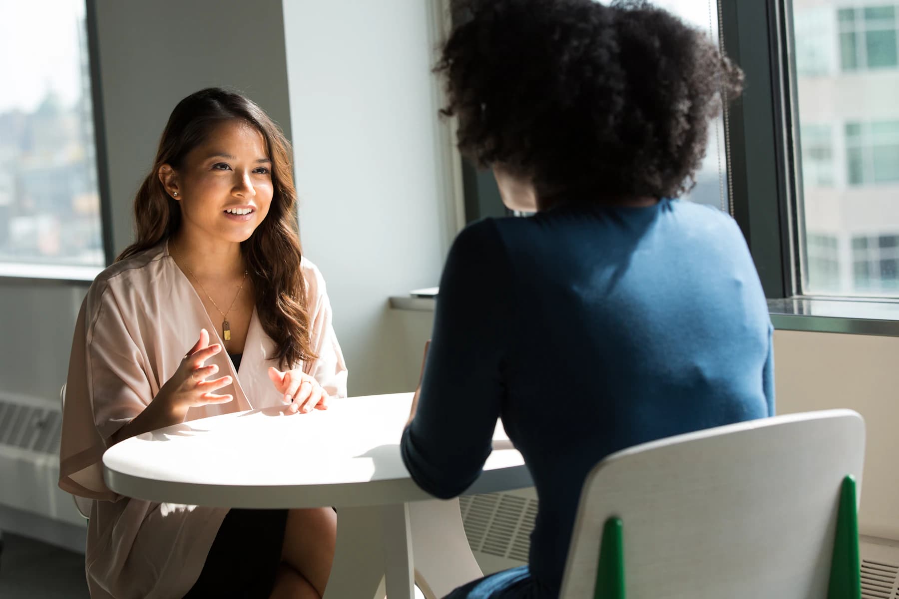 Two people in conversation during an illustrative working session